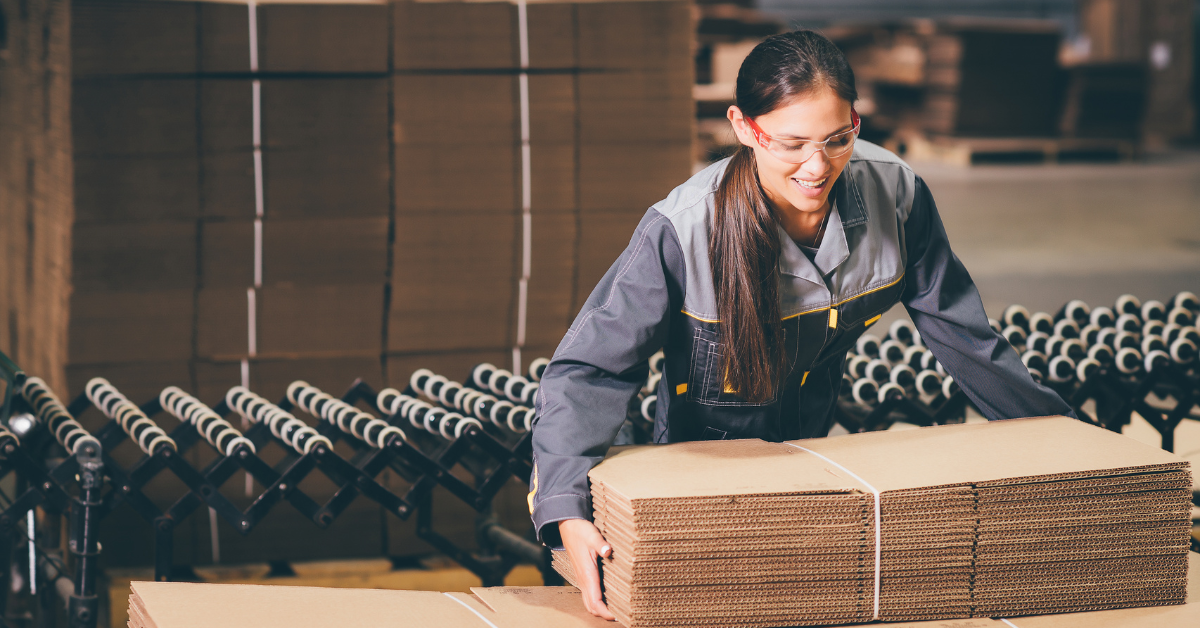 Female worker in a paper mill performing physically demanding tasks, representing a worker participating in a work hardening program to safely return to full-duty work.