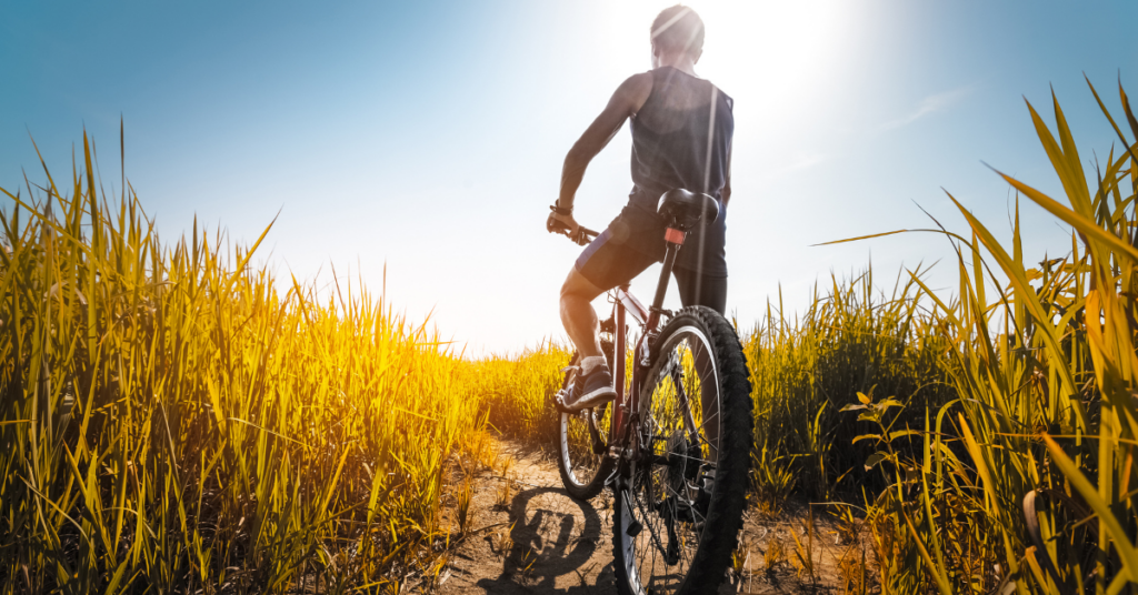 A person riding their bike on a scenic trail, enjoying the outdoors during spring in Central Wisconsin.